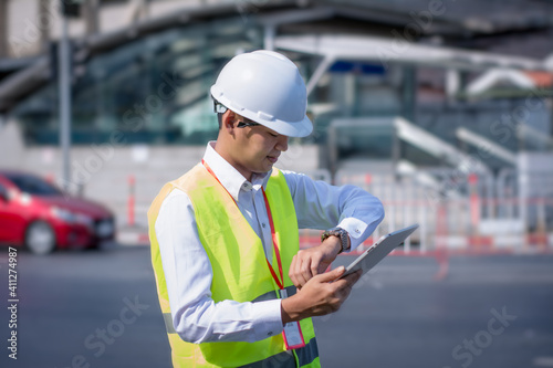 Portrait asian manager engineer,at work on outside,survey 5G signal network system,using digital tablet online control outdoor site,concept action business working industry telecommunication © ART STOCK CREATIVE