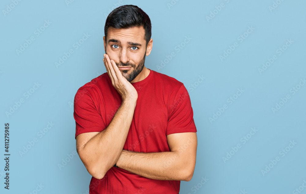 Young hispanic man wearing casual clothes thinking looking tired and bored with depression problems with crossed arms. Young hispanic man wearing casual clothes thinking looking tired and bored with depression problems with crossed arms.