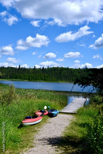 three kayaks on a path to the lake