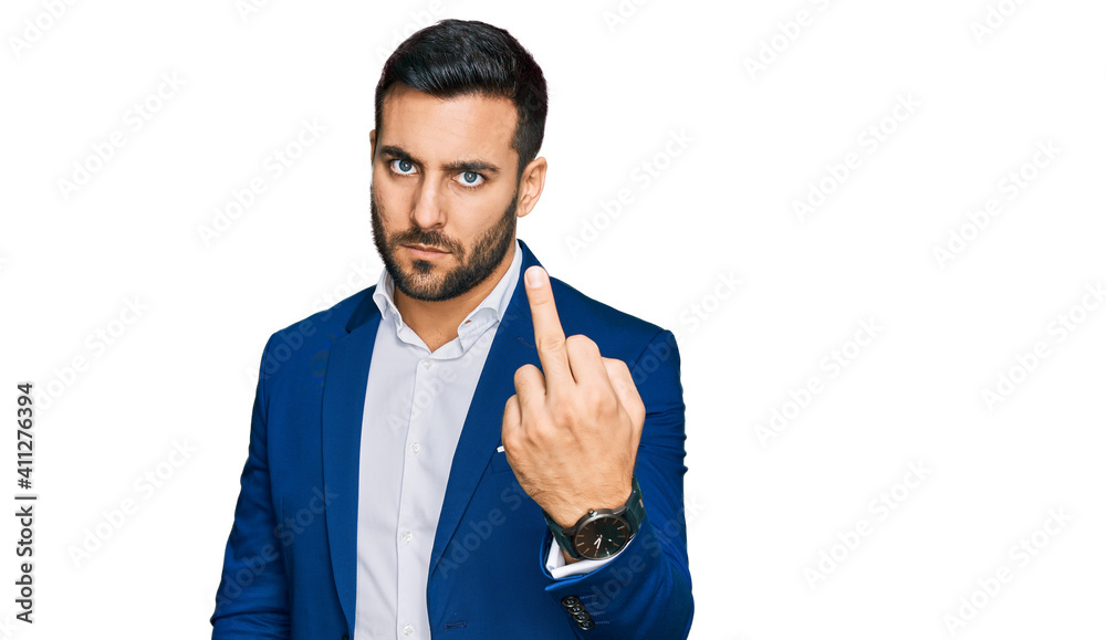 Young hispanic man wearing business jacket showing middle finger, impolite and rude fuck off expression Young hispanic man wearing business jacket showing middle finger, impolite and rude fuck off expression