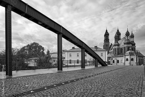 The steel structure of the bridge and the towers of the Gothic Catholic cathedral