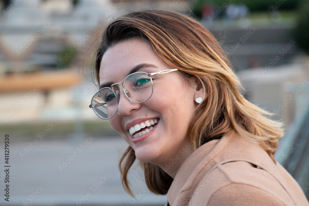 Closed up of a sophisticated woman smiles and enjoys the views of the city of Barcelona Closed up of a sophisticated woman smiles and enjoys the views of the city of Barcelona