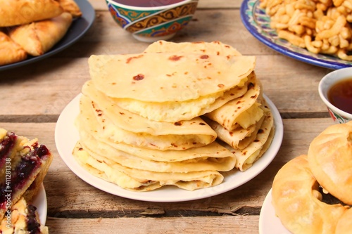 Traditional Tatar Cuisine, Kystybyi (Flatbread With Mashed Potato) On Wooden Table. Close Up, Side View. photo