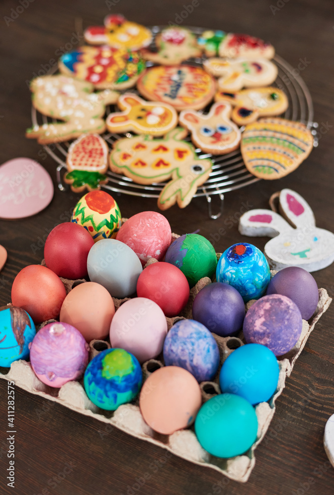 Close-up of Easter eggs and gingerbread cookies on the table prepared for Easter holiday Close-up of Easter eggs and gingerbread cookies on the table prepared for Easter holiday