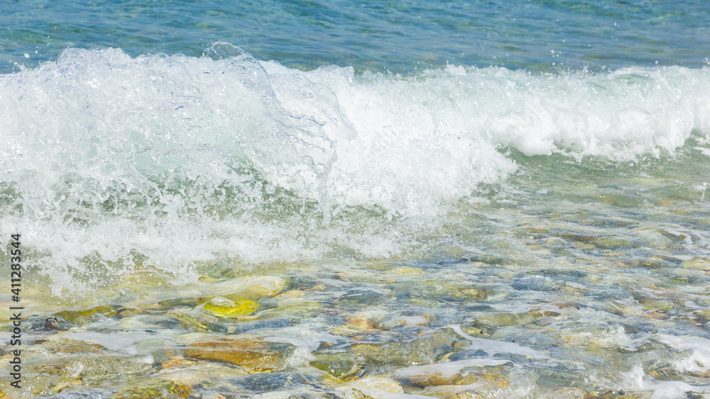Sea wave and pebble. Summer vacation concept. Sea wave with foam incident on the coastal shingle. Travel concept Sea wave and pebble. Summer vacation concept. Sea wave with foam incident on the coastal shingle. Travel concept