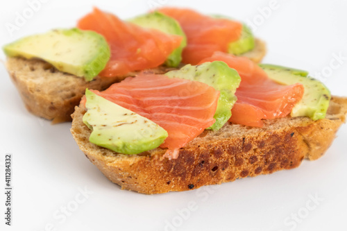 Homemade Toast sandwich with Salmon, Avocado on on a slice of grain bread. healthy food