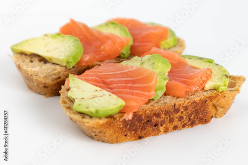 Homemade Toast sandwich with Salmon, Avocado on on a slice of grain bread. healthy food