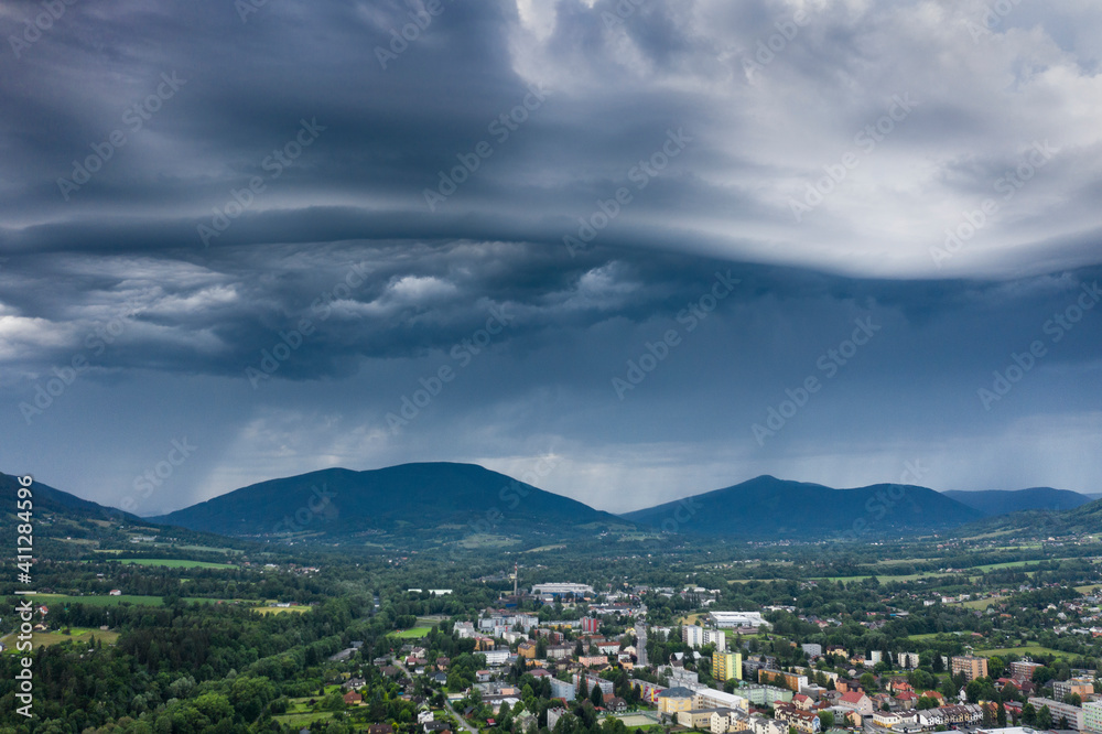 Dramatic landscape with stormy clouds over a town aerial view