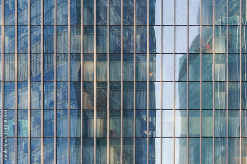 Moscow offices building exterior in winter sunny day. Blue sky had been reflected in the glass of windows. Futuristic business concept.