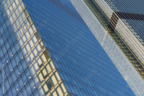 Moscow offices building exterior in winter sunny day. Blue sky had been reflected in the glass of windows. Futuristic business concept.