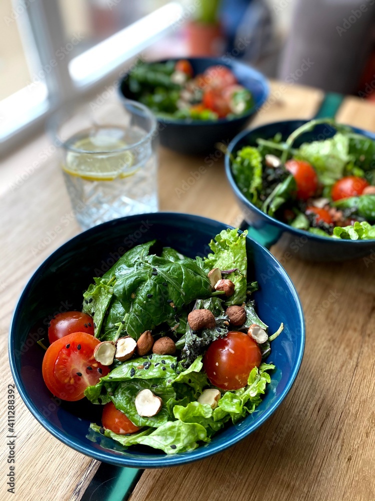 Top view of fresh vegetable salad on a plate on a wooden background. healthy food Top view of fresh vegetable salad on a plate on a wooden background. healthy food