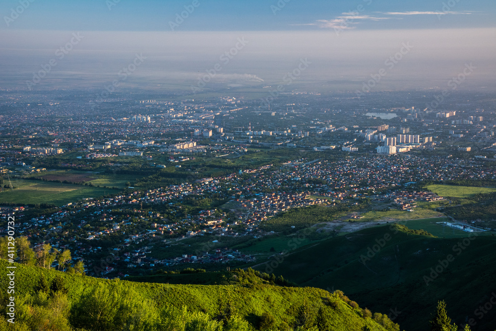 A view of the city from the height of the mountains in the early morning . Almaty, Kazazakhstan.