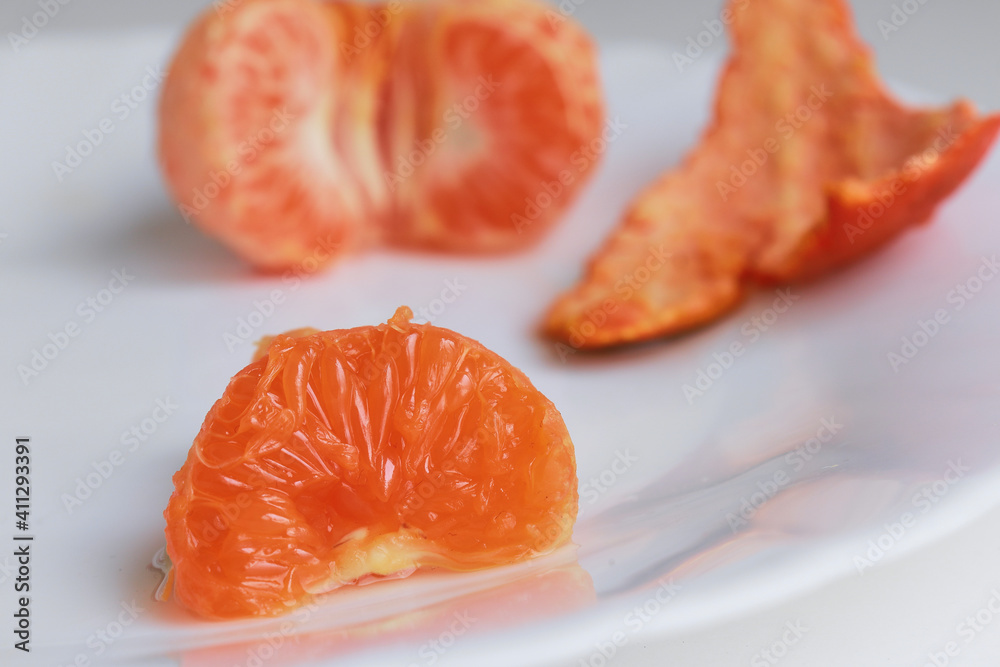 macro photo mandarin slices in a white plate close up several pieces of lie on the table background out of focus macro photo mandarin slices in a white plate close up several pieces of lie on the table background out of focus