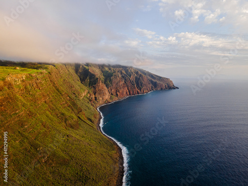 Stunning cliff coast of the island of Madeira at sunset - Steep coast with huge cliffs