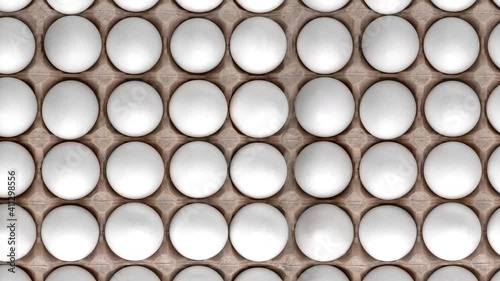 Top view pattern with white chicken raw eggs in carton recyclable cardboard box. natural shadow, easter concept