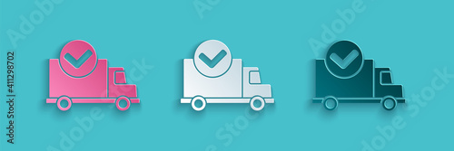 Paper cut Delivery truck with check mark icon isolated on blue background. Paper art style. Vector Illustration.