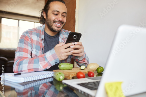 Young mature man taking cooking classes online