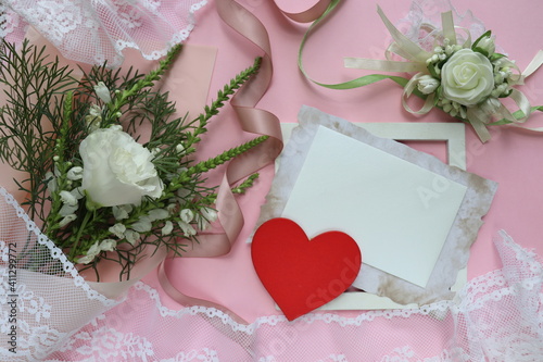 Happy Valentine's Day greeting card. flowers and red heart on a white background. space for text 