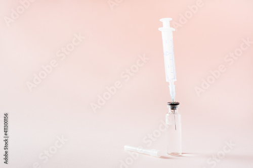 Vaccination and Immunization. Syringe needle inserted into a glass vial with vaccine