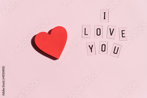 pink Background with one heart. Valentines day ,greeting card made with red heart . Cute love, romantic, wedding or mothers day concept. top view, copy space.happy Valentines day design with hearts