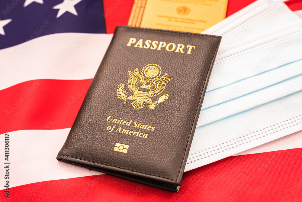 American passport with vaccination record on a flag. American passport with vaccination record on a flag.