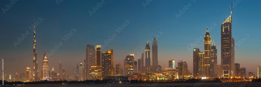 DUBAI, UAE - MARCH 31, 2017: The evening skyline of Downtown with the Burj Khalifa and Emirates Towers.