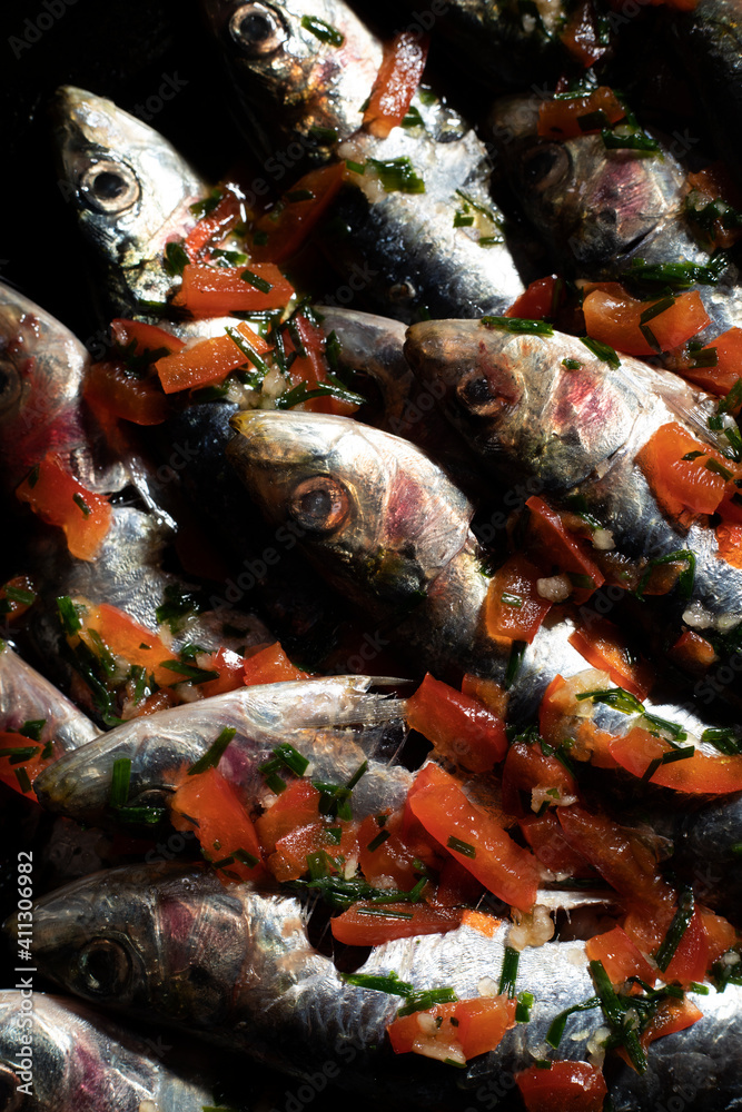 close-up photo of raw sardines with bell pepper and oil