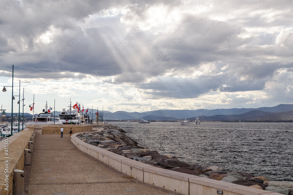 Embankment in the port of Saint-Tropez, France, in cloudy weather.