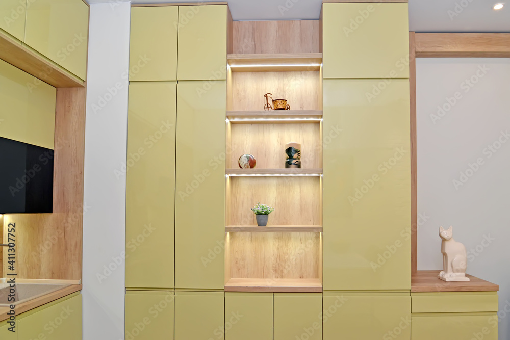 Fototapeta premium Cabinet furniture in a studio room combined with a kitchen. Modern minimalism