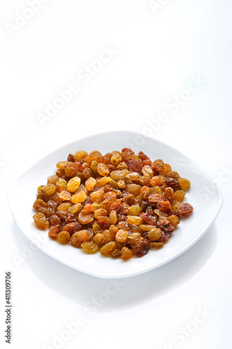Dried sweet golden raisins on isolate on white background copy space.