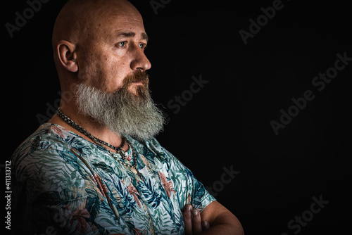close up, portrait of emotional, thoughtful, handsome positive young bearded businessman man. Low key isolated on dark background. Body language 