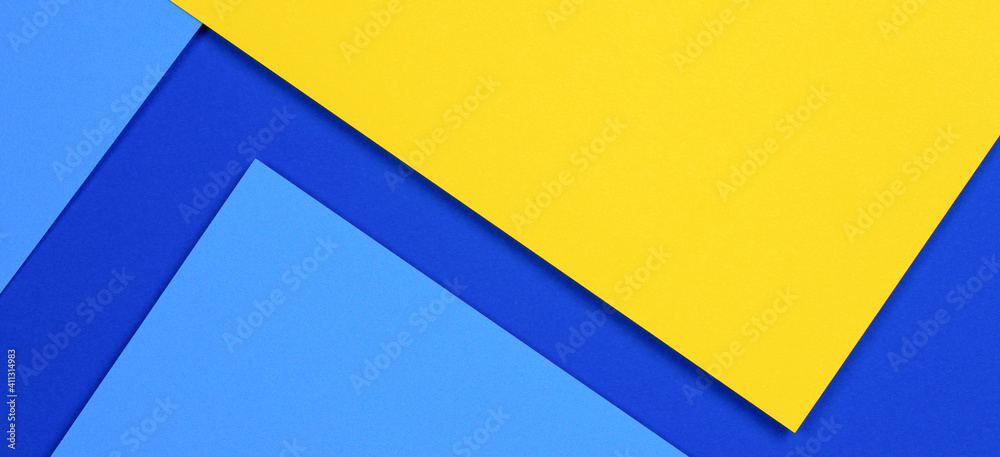 Creative abstract blue and yellow color geometric paper compositon background, top view Creative abstract blue and yellow color geometric paper compositon background, top view