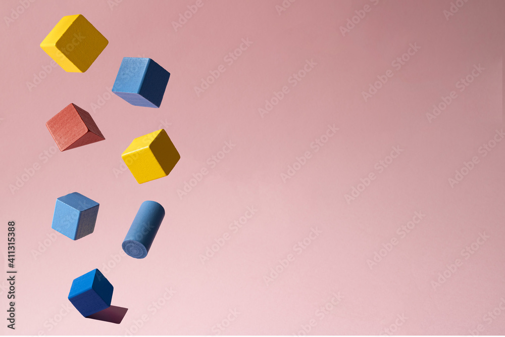 Creative arrangement with colorful wooden geometric objects against pastel pink background. Minimal concept. Creative arrangement with colorful wooden geometric objects against pastel pink background. Minimal concept.