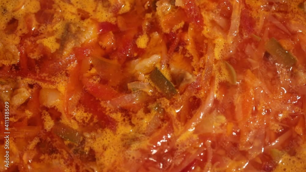 Ukrainian borsch is boiling in a saucepan, close-up. Red traditional ukrainian borsch with meat is being prepared. Macro video Ukrainian borsch is boiling in a saucepan, close-up. Red traditional ukrainian borsch with meat is being prepared. Macro video