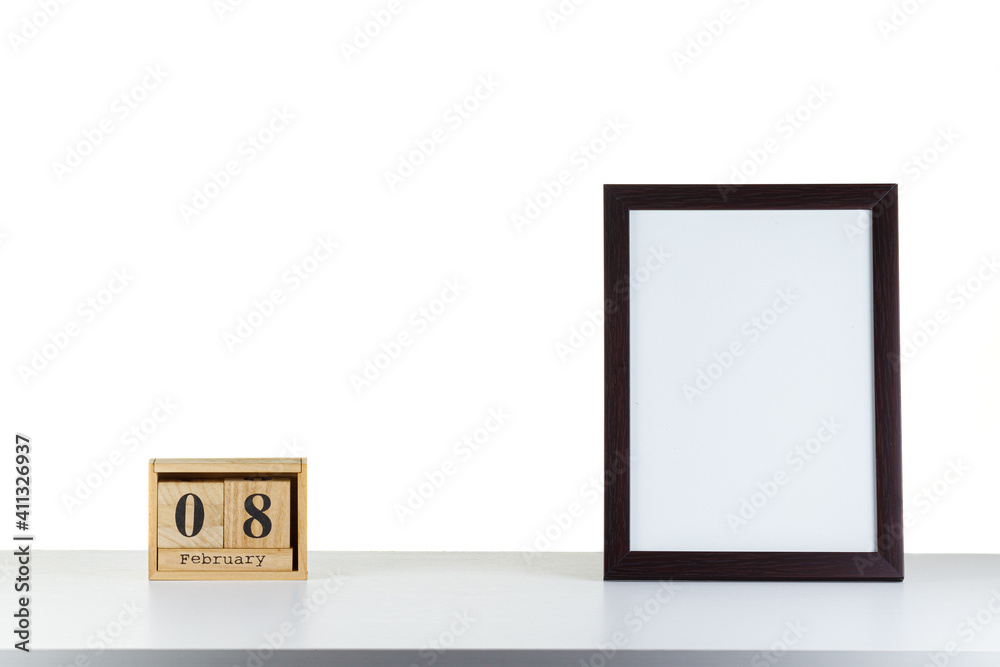 Wooden calendar 08 february with frame for photo on white table and background Wooden calendar 08 february with frame for photo on white table and background