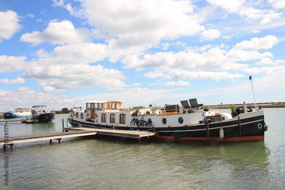 River boat in Villeneuve les Maguelone, a seaside resort in the south of Montpellier, Herault, France River boat in Villeneuve les Maguelone, a seaside resort in the south of Montpellier, Herault, France