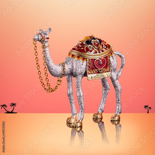 pearl color metal camel with decorative saddle and decorative stones