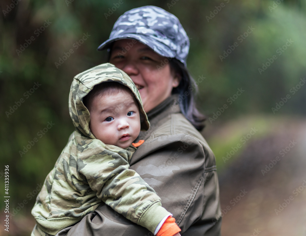 Happy family mother and baby hugging in Nature rainforest. Happy harmonious family outdoors. Happy family mother and baby hugging in Nature rainforest. Happy harmonious family outdoors.