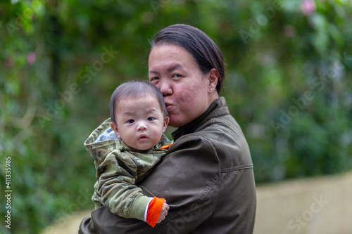 Happy family mother and baby hugging in Nature rainforest. Happy harmonious family outdoors.