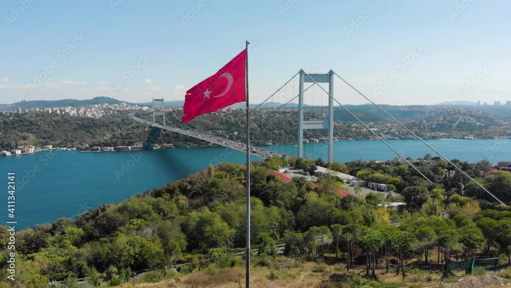 Aerial drone view of Fatih Sultan Mehmet Bridge (Second Bosphorus Bridge) and Turkish Flag at the day time in Istanbul, Turkey