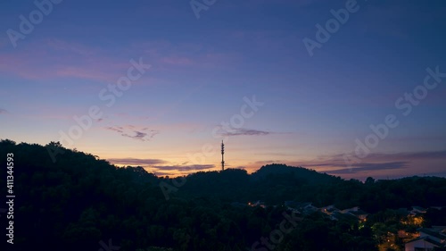 Cinematic Timelapse footage circle view of 5G Communication tower during morning sunrise with clouds, mists and fog