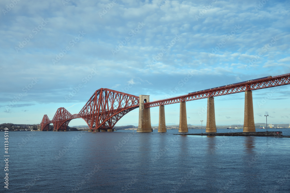 View of Forth Rail Bridge and a moving train. View of Forth Rail Bridge, the worlds longest cantilever bridge, Scotland, United Kingdom View of Forth Rail Bridge and a moving train. View of Forth Rail Bridge, the worlds longest cantilever bridge, Scotland, United Kingdom