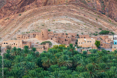 Palm trees and a traditional mountain village in Nizwa,Oman. photo