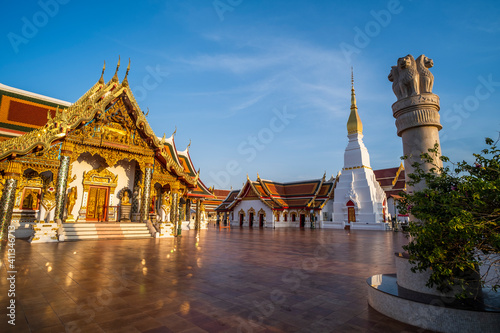 Sculpture of Wat Phra That Choeng Chum Worawihan In the time when the sun sets Tourist attractions in Sakon Nakhon Province, Thailand photo