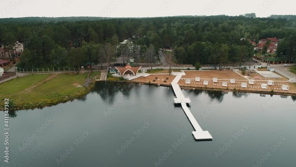 Beautiful aerial view of river and buildings in countryside on summer day during travel. Beautiful aerial view of river and buildings in countryside on summer day during travel.