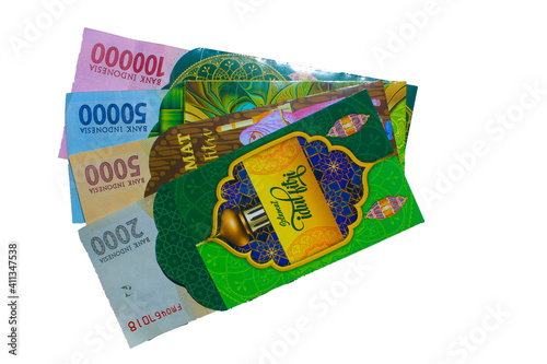 Indonesian money, rupiah / IDR in envelopes with THR Text. THR is a holiday allowance at Iedul Fitri or Eid. photo