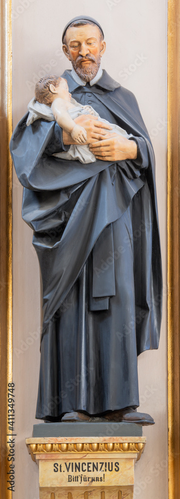 VIENNA, AUSTIRA - OCTOBER 22, 2020: The carved polychome sculpture of  St. Vincent de Paul in the church St. John the Evangelst by Josef Urbania (1924).