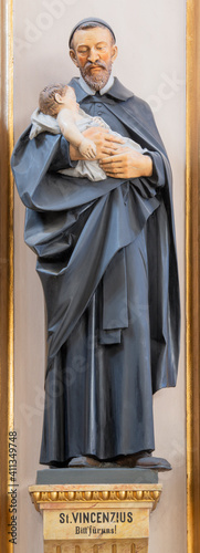 VIENNA, AUSTIRA - OCTOBER 22, 2020: The carved polychome sculpture of  St. Vincent de Paul in the church St. John the Evangelst by Josef Urbania (1924). photo