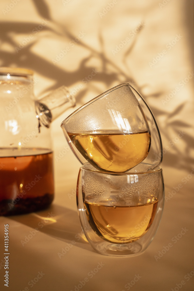 Double-bottom glasses are stacked on top of each other. Natural motives in warm colors. Breakfast glasses with tea. Double-bottom glasses are stacked on top of each other. Natural motives in warm colors. Breakfast glasses with tea.
