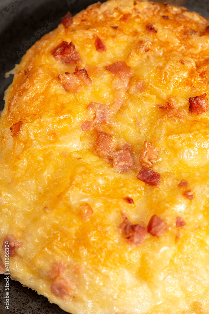Savoury white bread roll with melted cheese and bacon Savoury white bread roll with melted cheese and bacon